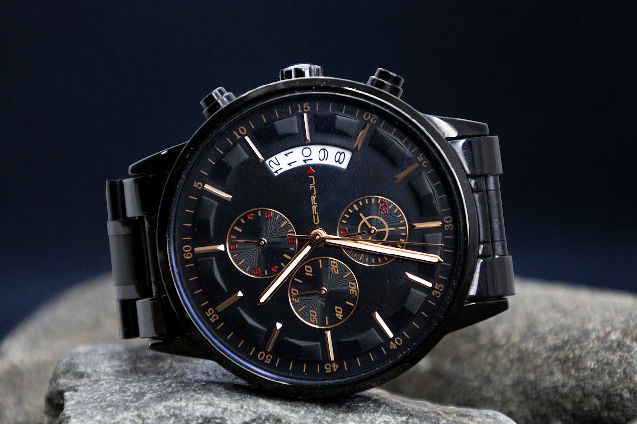 Close-up of a stylish black chronograph wristwatch showcasing its intricate dial design.